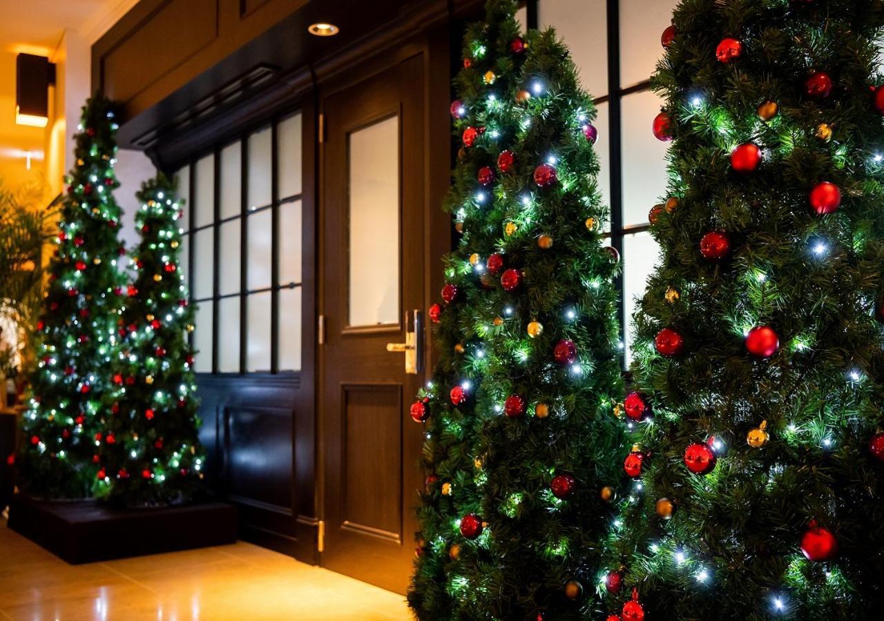 Hotel Monterey Okinawa Spa & Resort Onna Exterior photo Christmas trees at the entrance of a hotel